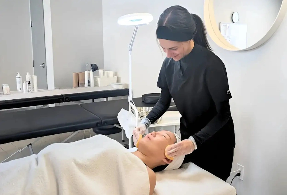 Facial being performed on a woman's face